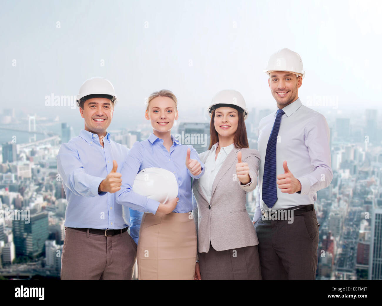 happy business team in office showing thumbs up Stock Photo - Alamy