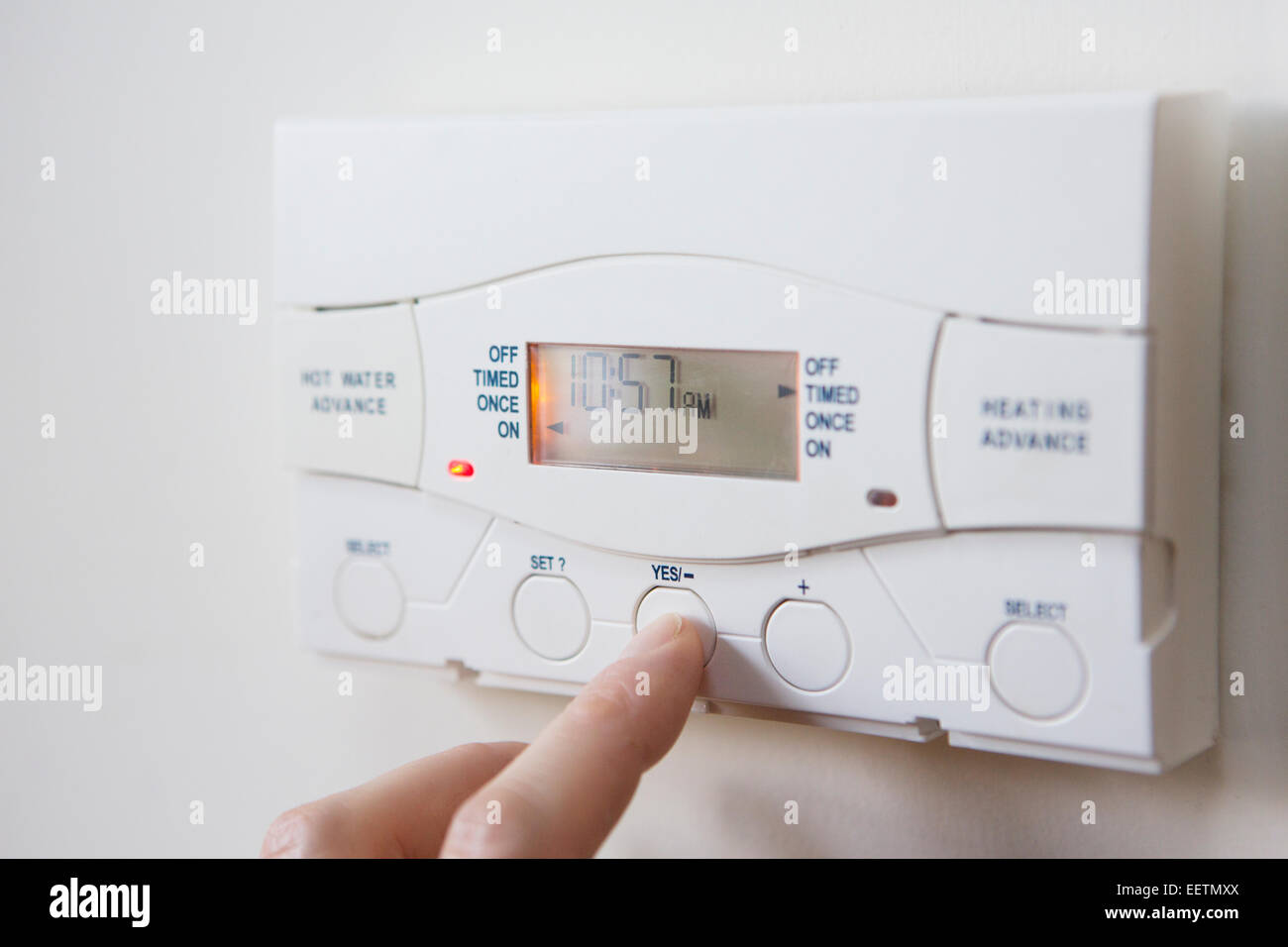 Close Up Of Hand  Setting Control For Heating And Hot Water Stock Photo