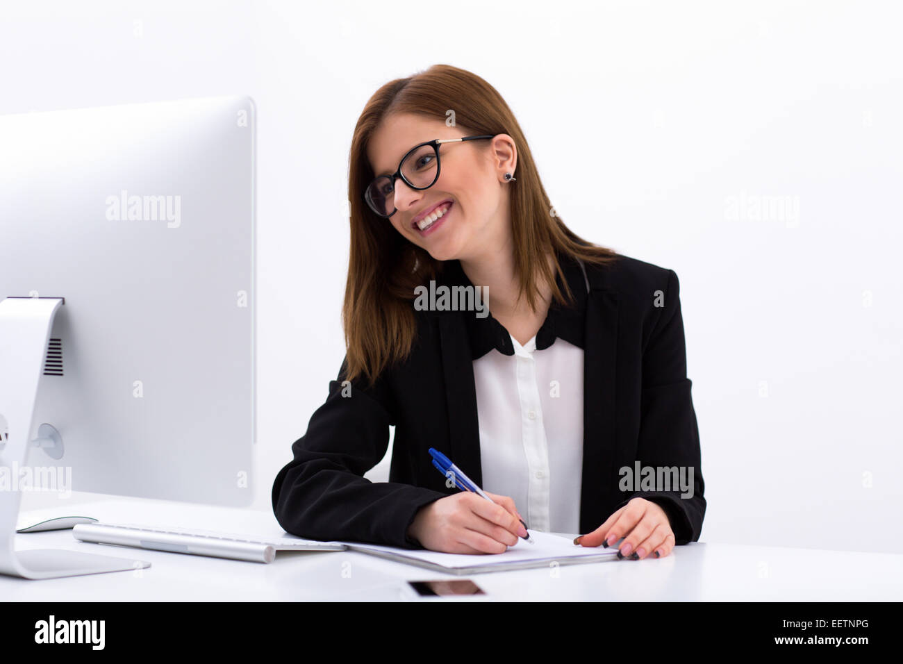 Young happy businesswoman working at the office Stock Photo - Alamy