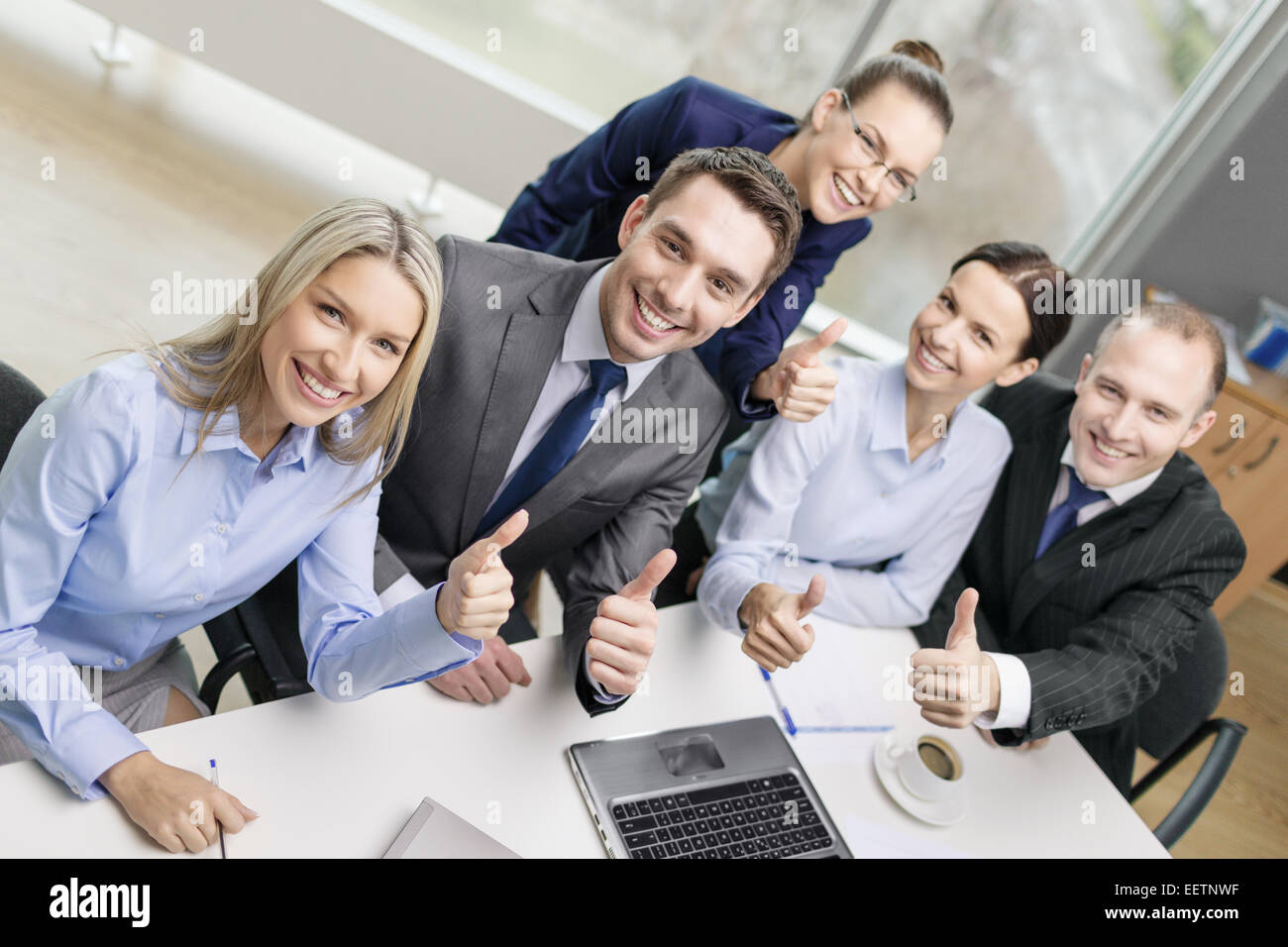 business team showing thumbs up in office Stock Photo - Alamy