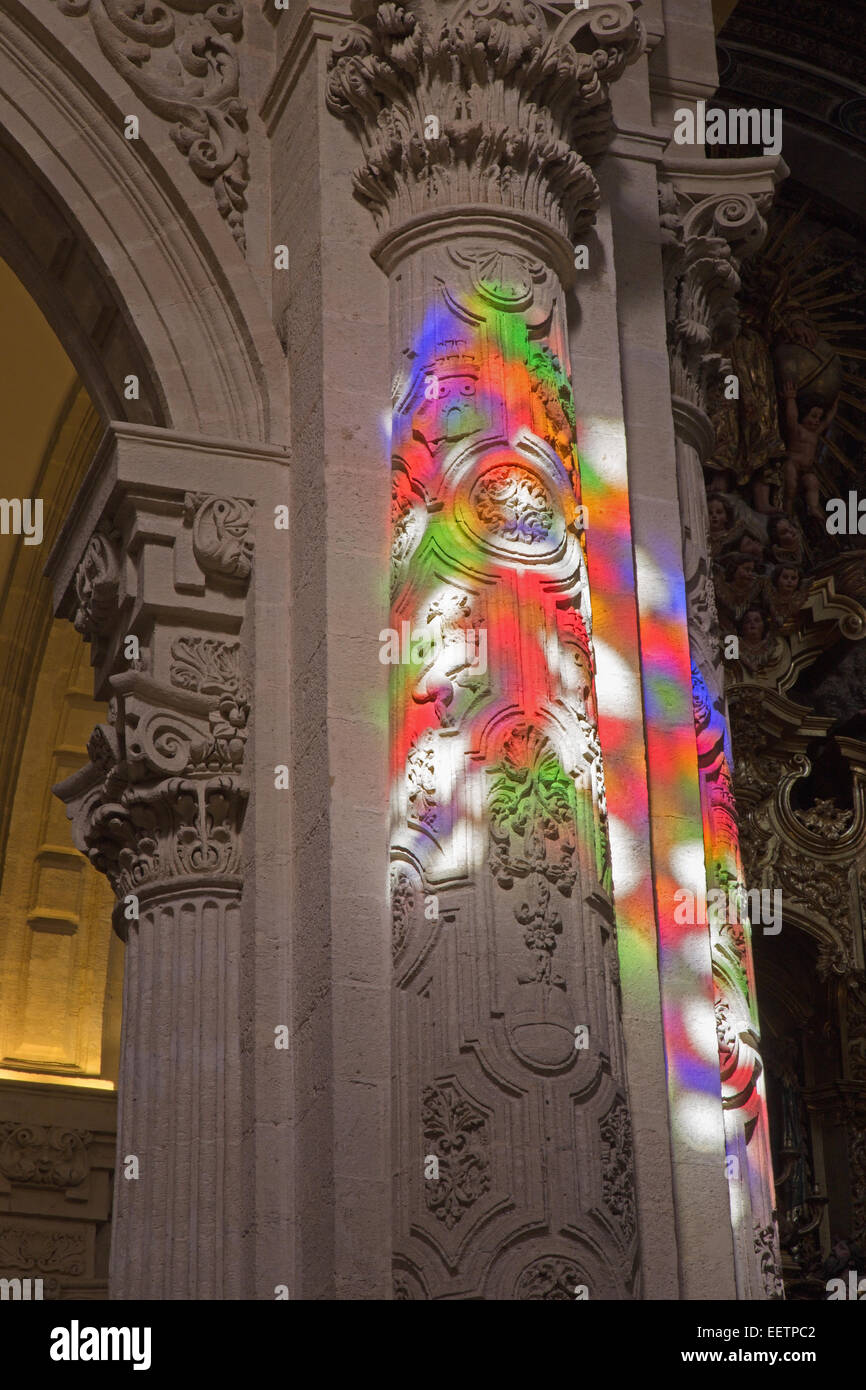 SEVILLE, SPAIN - OCTOBER 28, 2014: The windowpane light on the column baroque Church of El Salvador (Iglesia del Salvador). Stock Photo