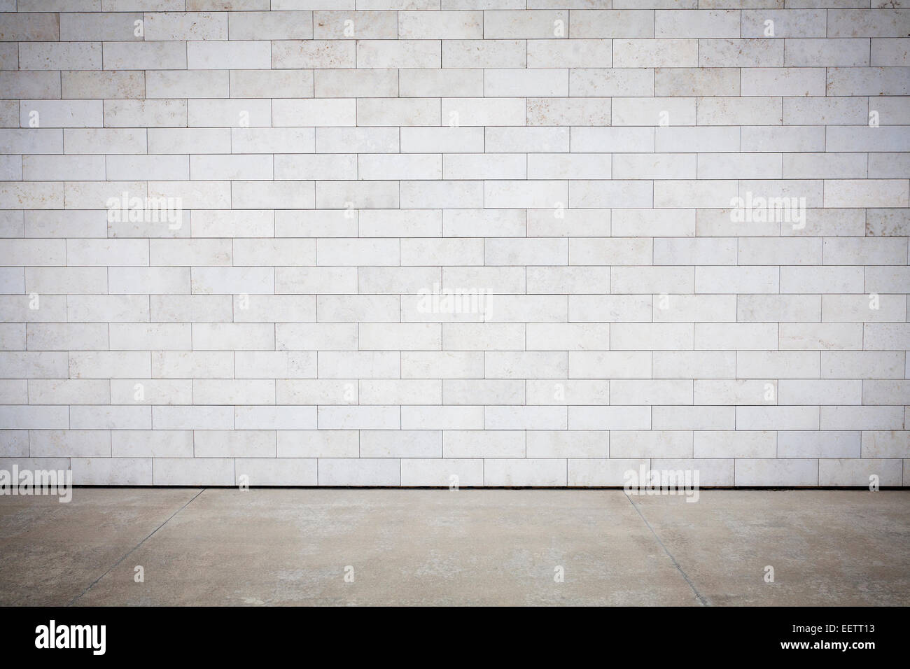 Tiled wall with a blank white bricks and concrete floor Stock Photo Alamy
