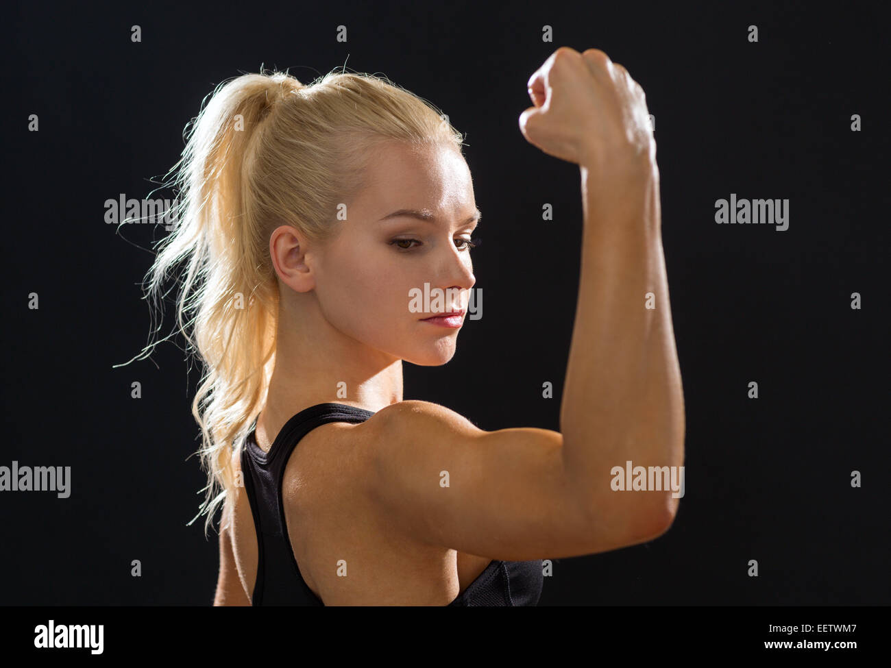 close up of athletic woman flexing her biceps Stock Photo