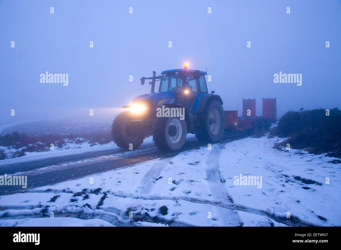 Mynydd Epynt, Powys, UK. 21st January, 2015. UK weather.  A tractor and trailer drive through the fog along a narrow lane on the Epynt moorland in Powys. Credit:  Graham M. Lawrence/Alamy Live News. Stock Photo
