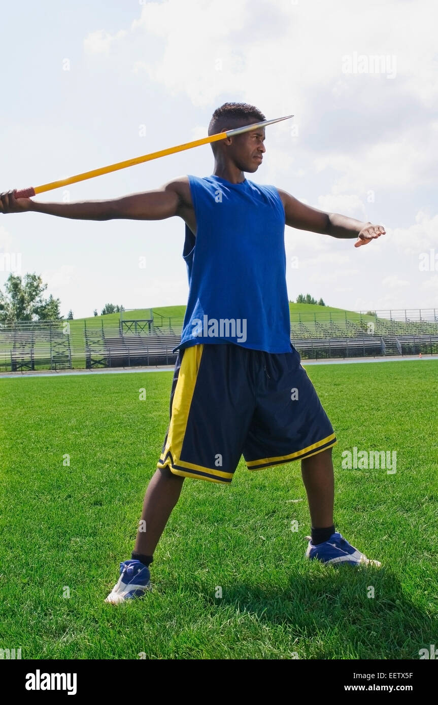 Man with javelin on field Stock Photo