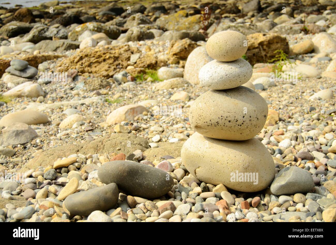 Stacked pebbles on the beach below King's Cave near Machrie on the Isle of Arran, Scotland Stock Photo