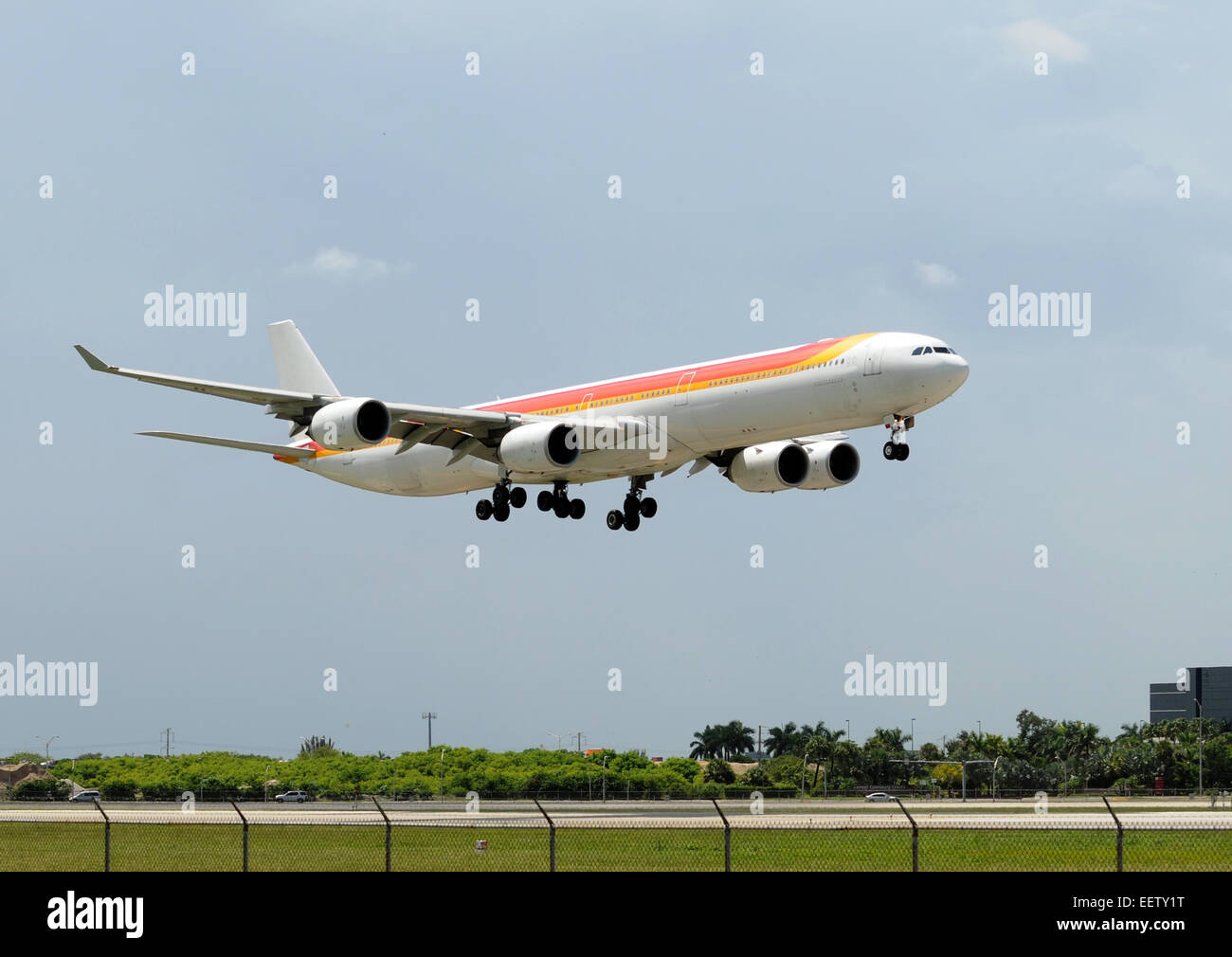 Heavy widebody jet airplane moments before landing Airbus A-340 Stock Photo