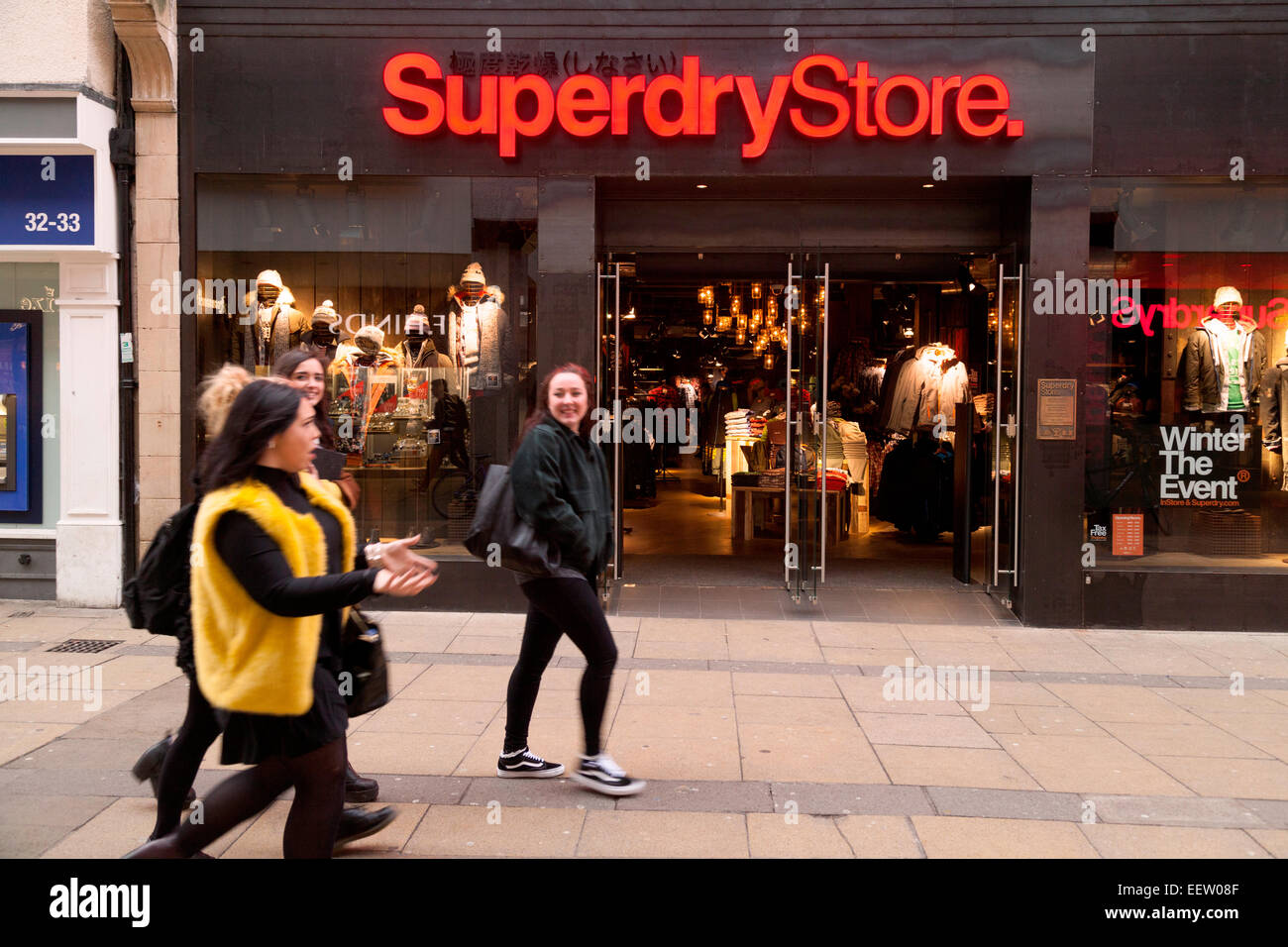 Young women walking past the Superdry Store, Cambridge, UK Stock Photo -  Alamy