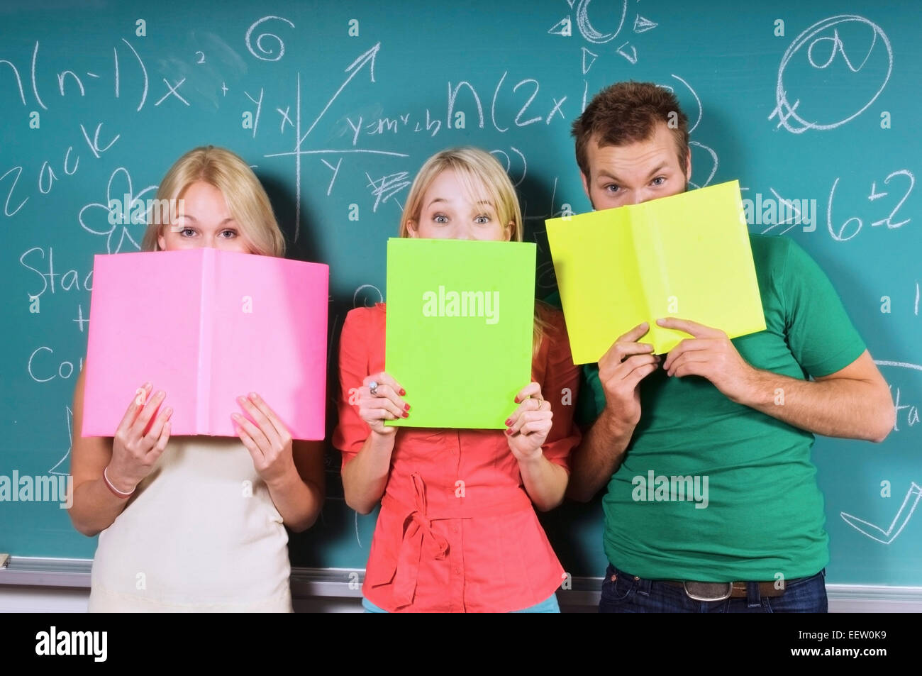 Three college students by a chalkboard Stock Photo Alamy
