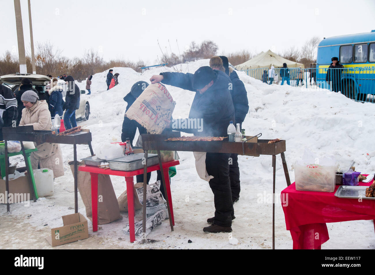 PETROPAVLOVSK, KAZAKHSTAN- JANUARY 19, 2015: man cooks barbecue. Orthodox church Holy Epiphany Day Stock Photo