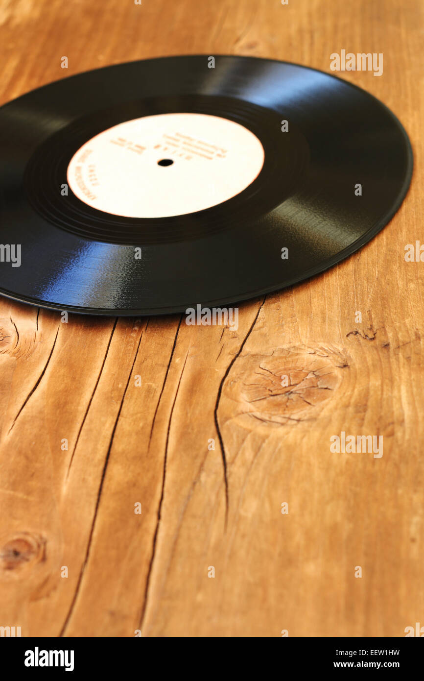 Old gramophone record on a wooden background Stock Photo