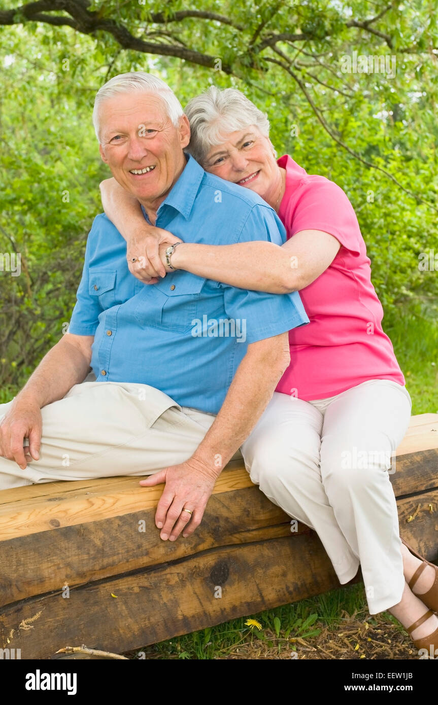 Senior couple sitting on bench Stock Photo - Alamy