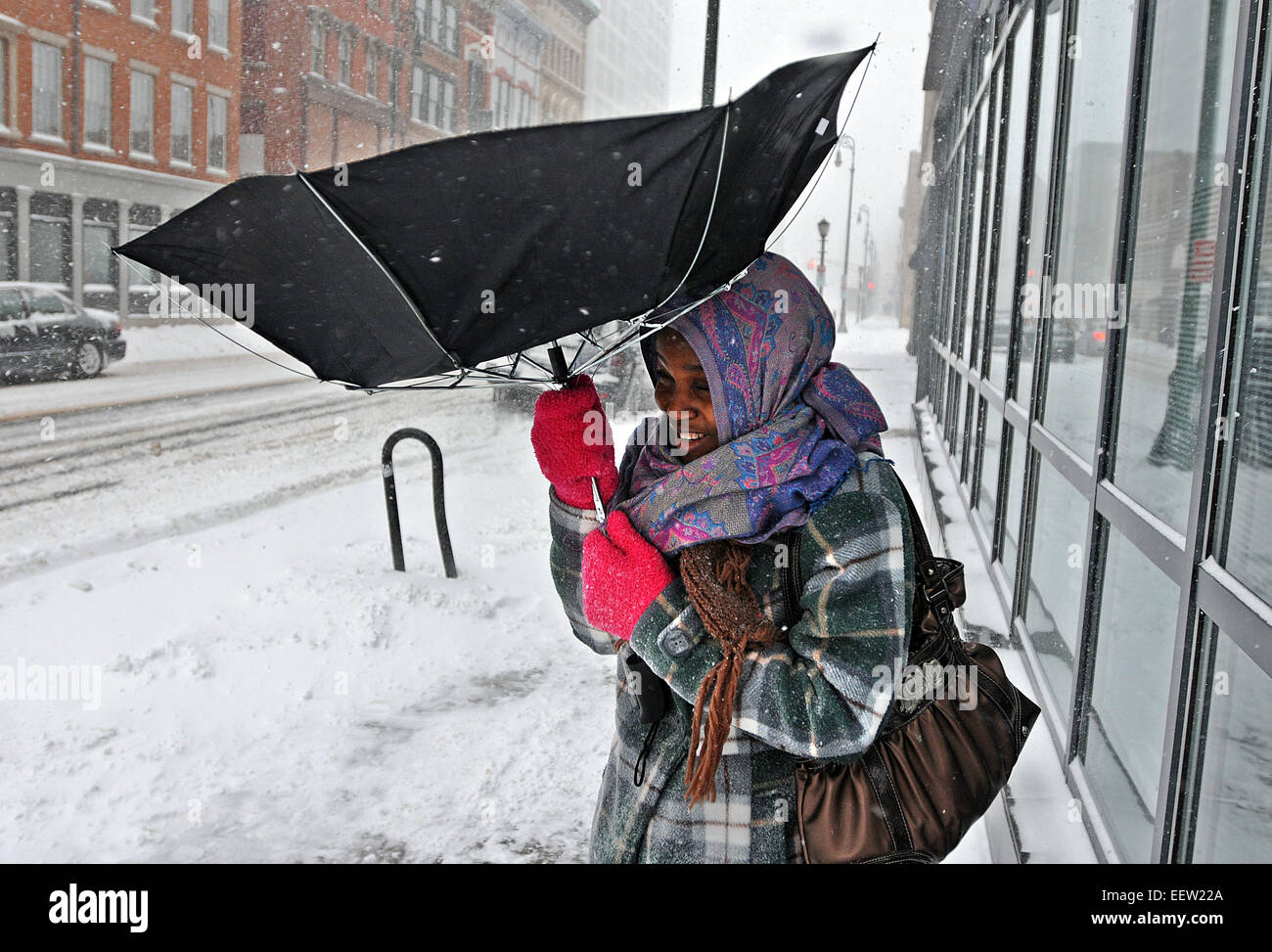 New Haven--Aichatou Awalou of West Haven battles the strong winds along Chapel Street downtown in New Haven as she tries to catch a bus during the storm Saturday.   01/21/12 Stock Photo