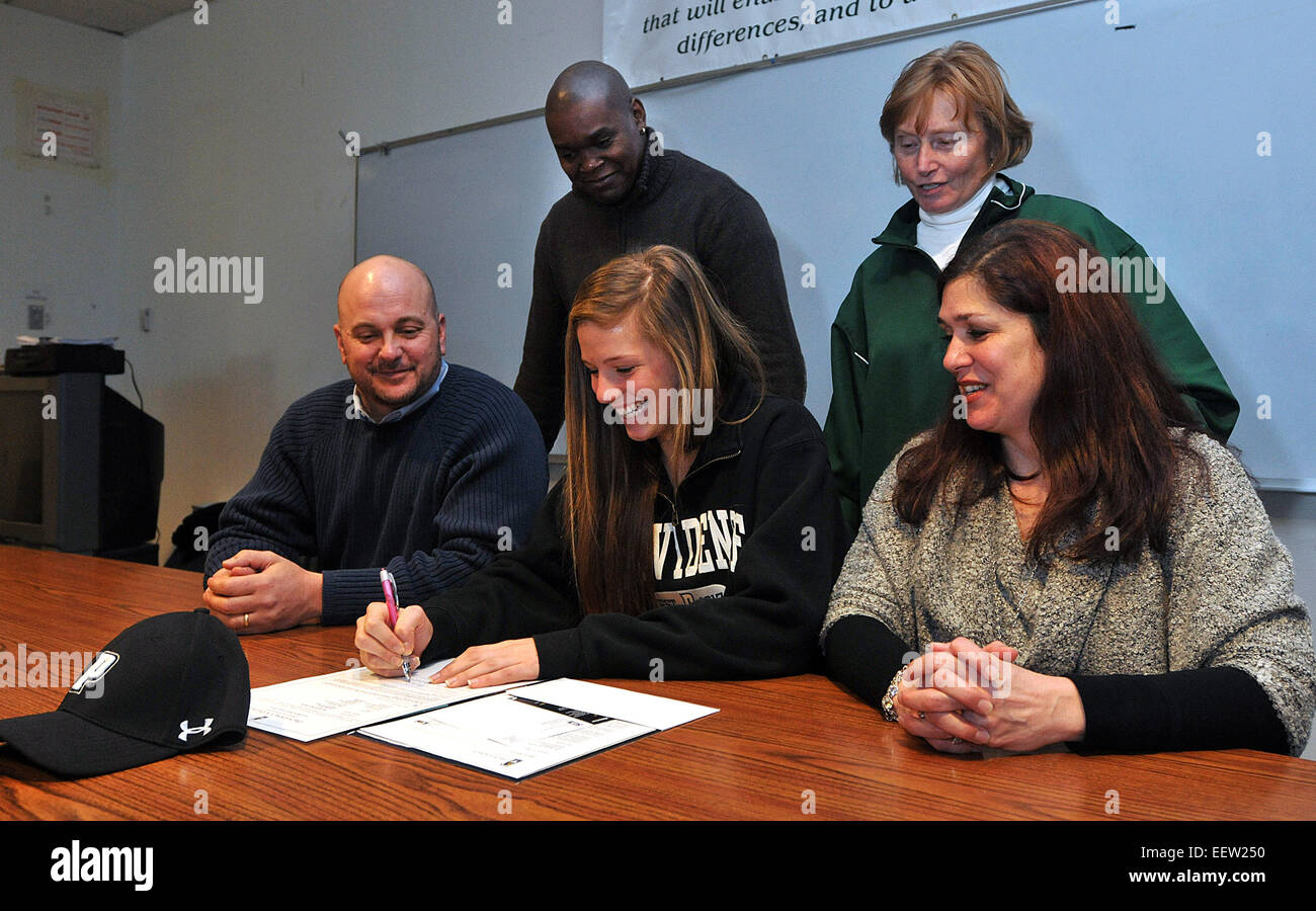 Hamden-- Hamden High soccer star Rachel Ogolik signs a letter of intent to play at Providence during a ceremony at the school. She is shown with her parents, Bob and Jana (seated) and her coach, Gary Collins and the athletic director, Jeanne Cooper. Photo-Peter Casolino 2/4/13 Stock Photo