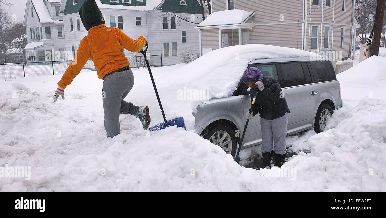 New Haven--Heavy rains make shoveling difficult for sisters, Troi, left and Lynnae Branham as they try to dig out the family car on Lakeview Terrace Stock Photo