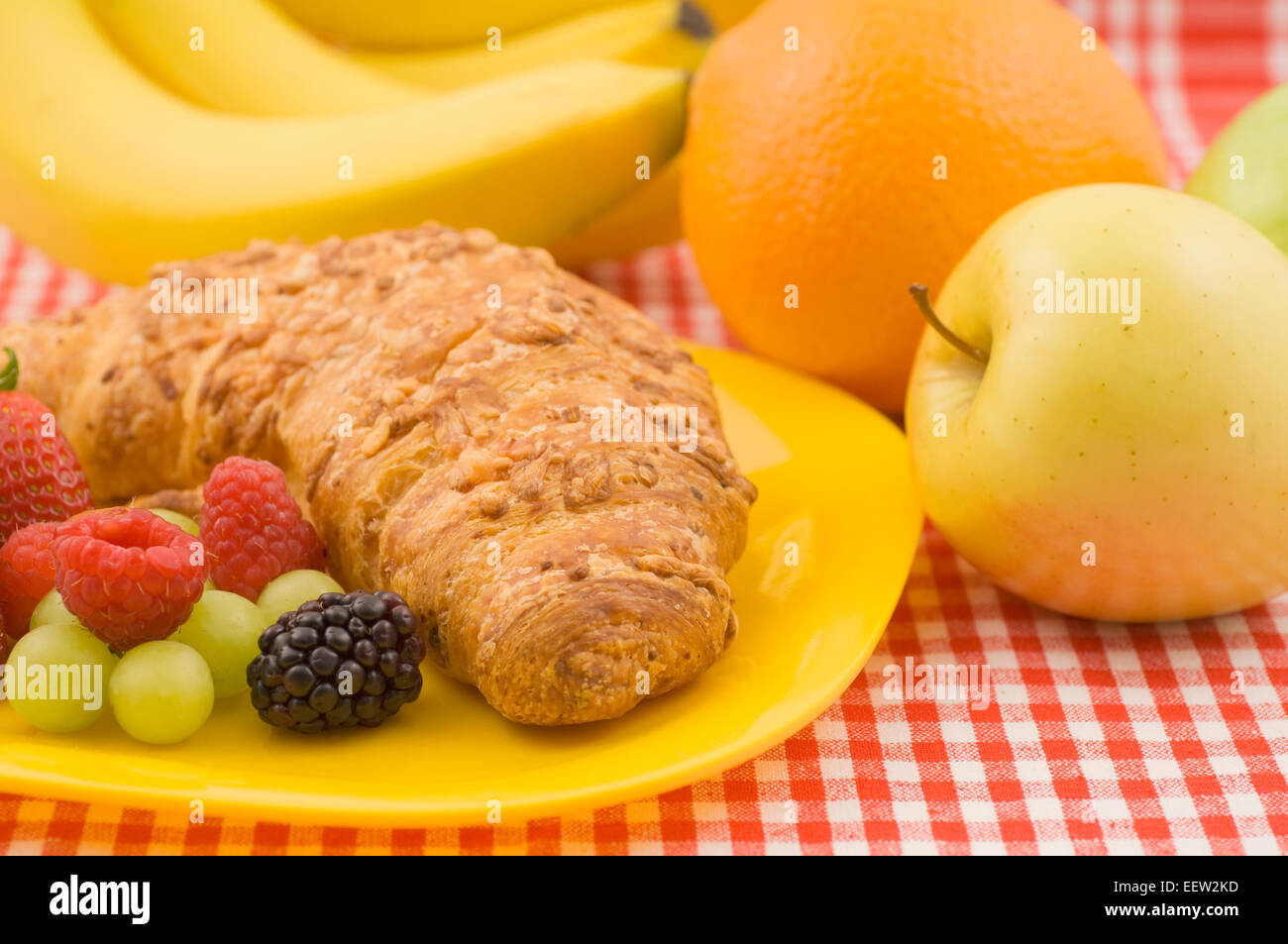 Croissant pastry with fruit garnish Stock Photo