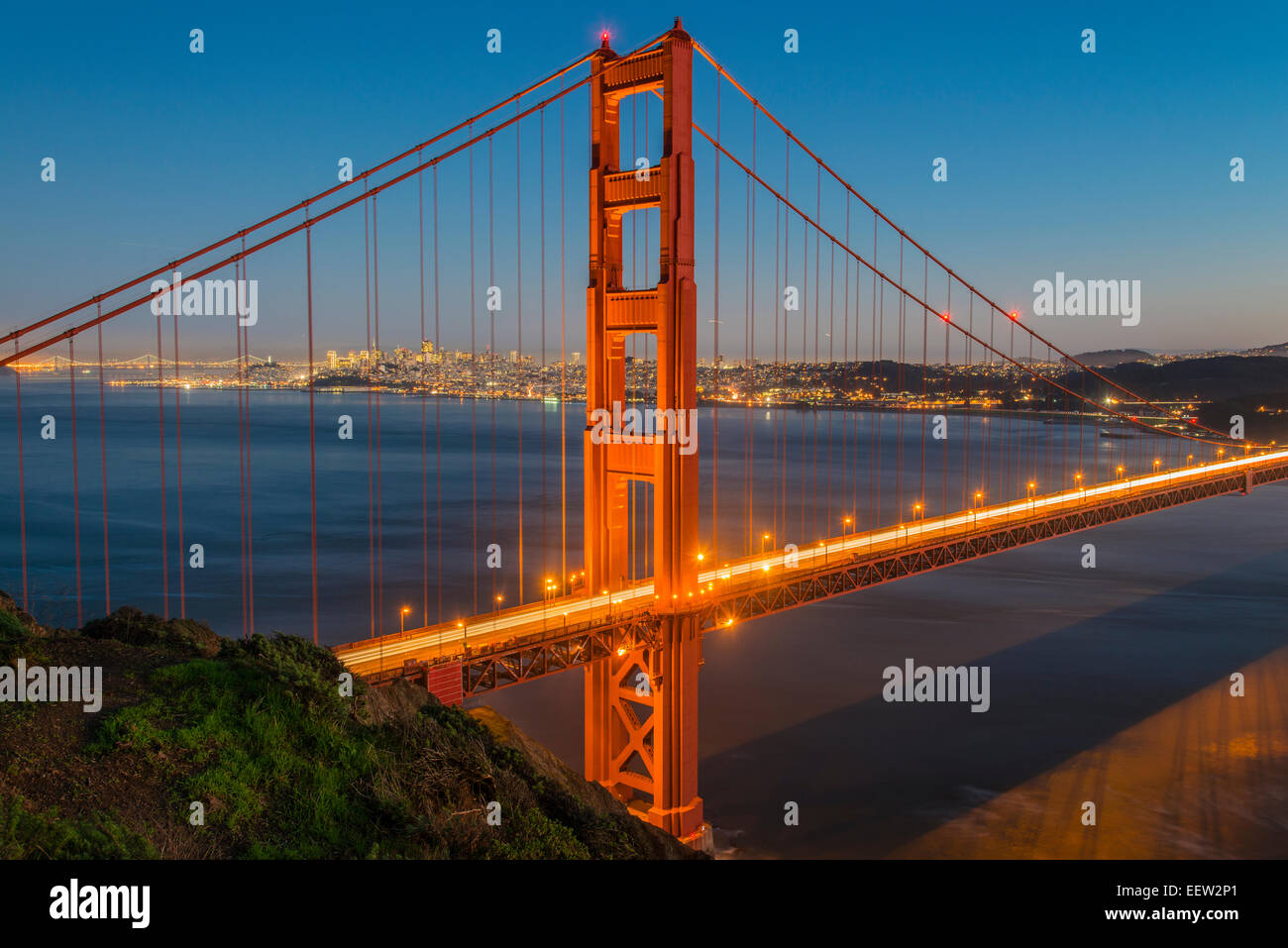 Night view of the Golden Gate suspension bridge with city skyline in ...