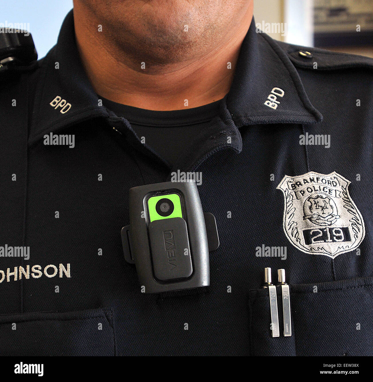 Branford CT USA-- Branford Police officer Jim Johnson wears one of the department's new VieVu personal camera, which is flicked on when needed. Stock Photo