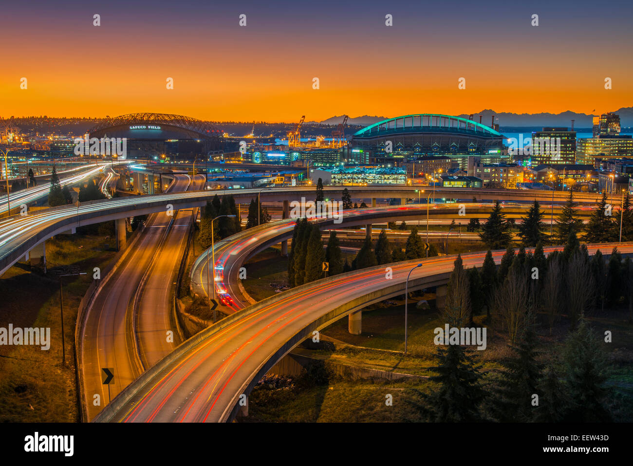 Freeway interchange and CenturyLink Field Stadium under dramatic sunset, Seattle, Washington, USA Stock Photo