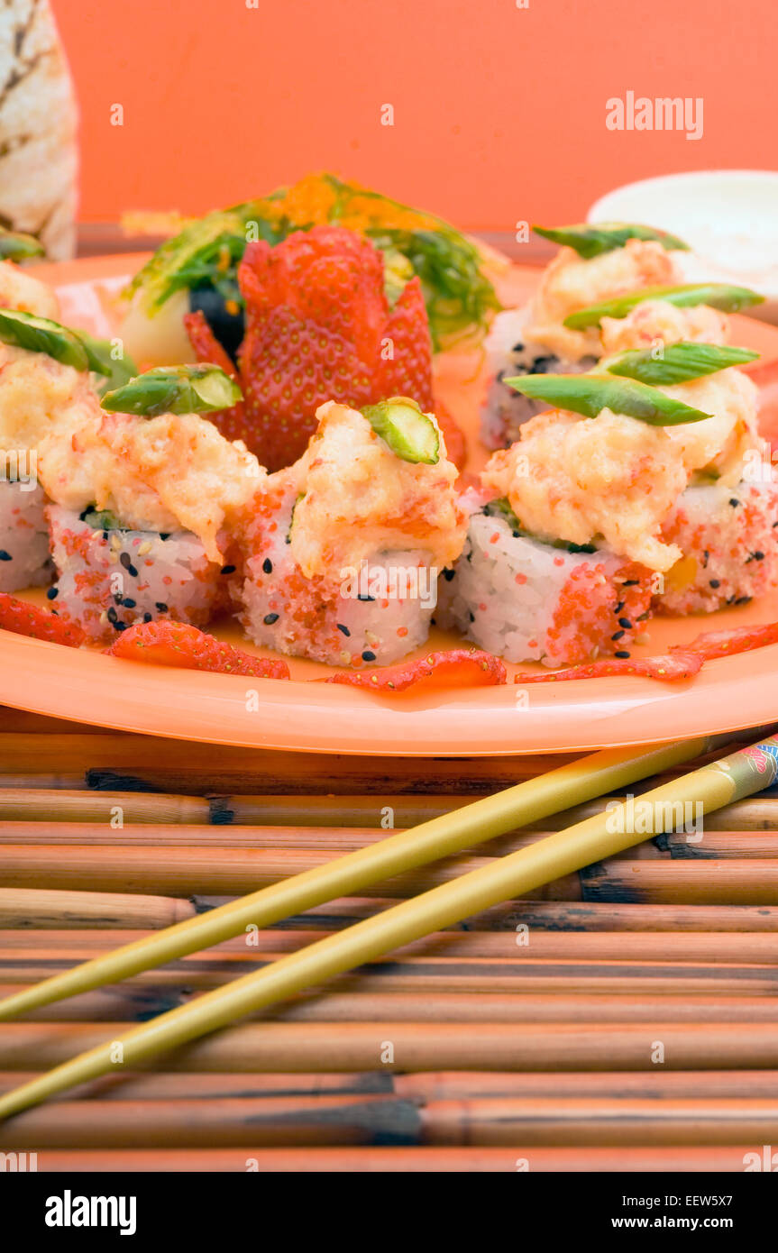 Spicy scallops sushi rolls with strawberries garnish Stock Photo Alamy