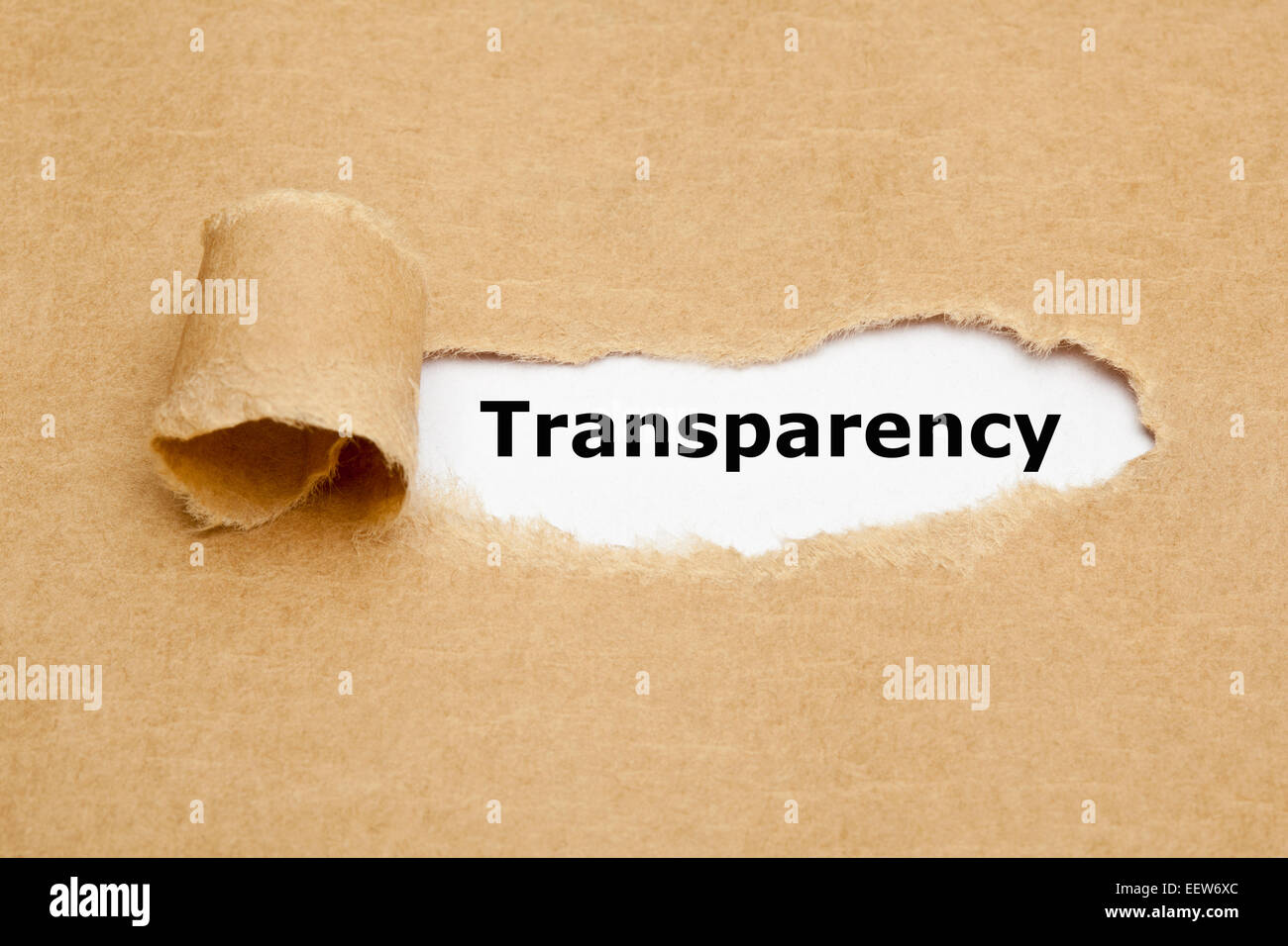 The word Transparency appearing behind torn brown paper. Stock Photo