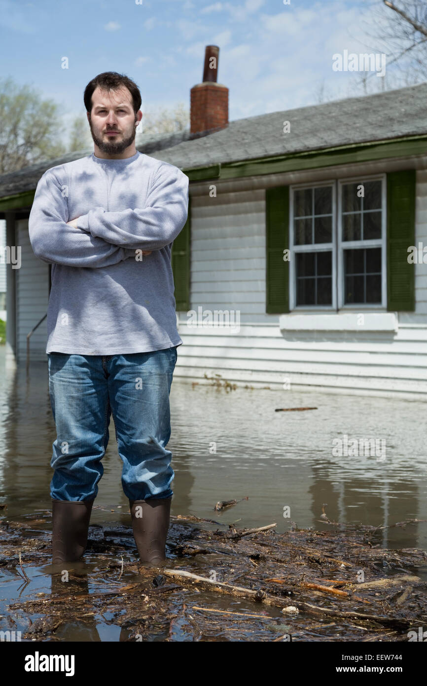 Man standing in front of flooded house Stock Photo - Alamy