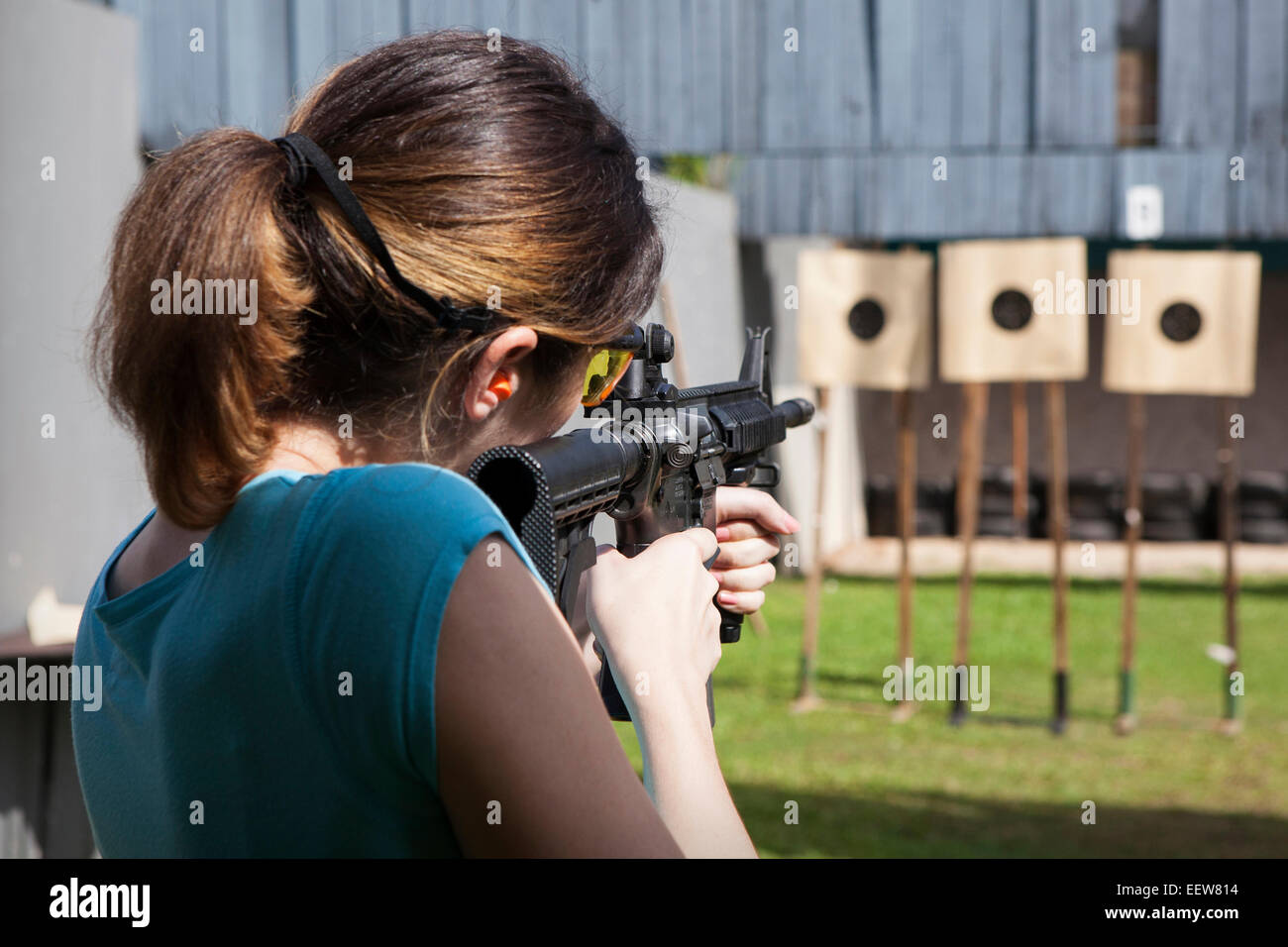A woman shooting on a range Stock Photo