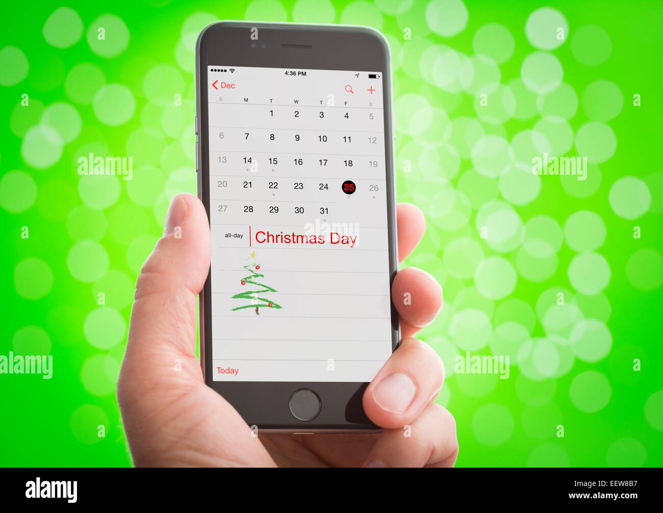 Hand Holding Smartphone With Christmas Day Marked On Calendar Stock