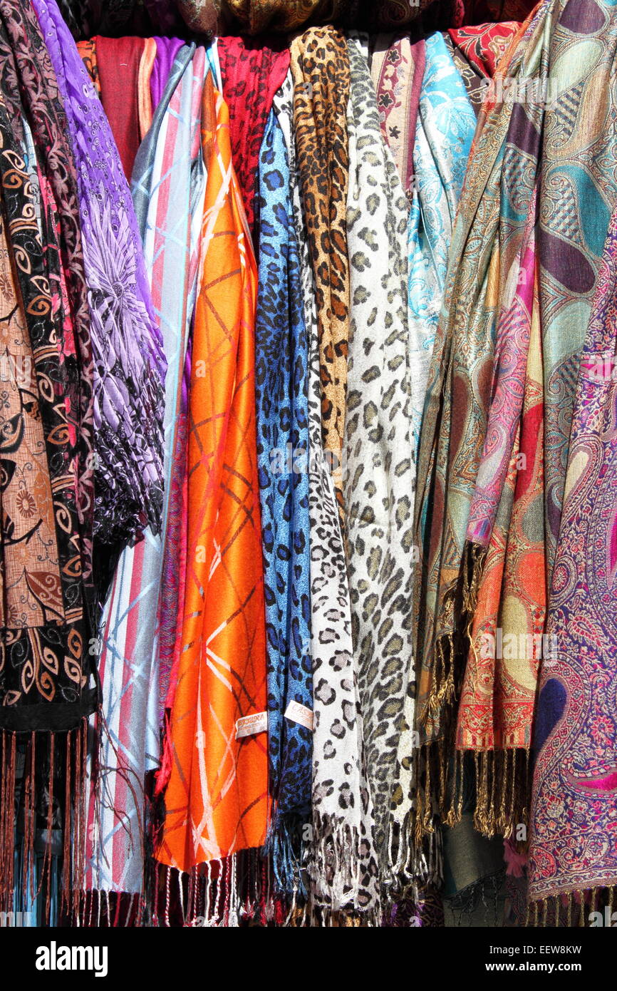 Colorful scarves hanging in a shelf of a fashion shop Stock Photo