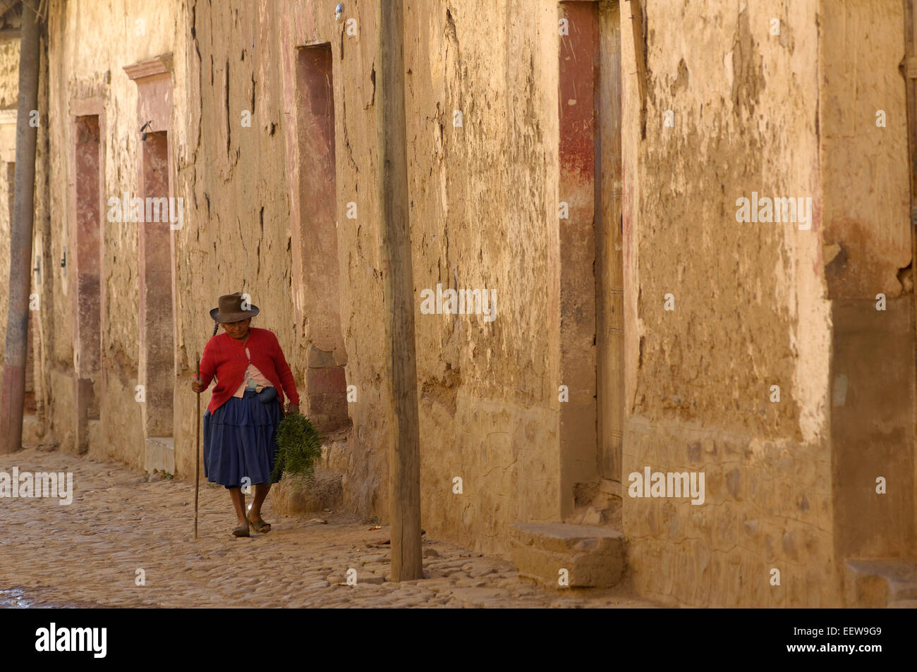 A woman makes her way along one of the streets in the old colonial town of Tarata, in the Cochabamba district of Bolivia. Stock Photo