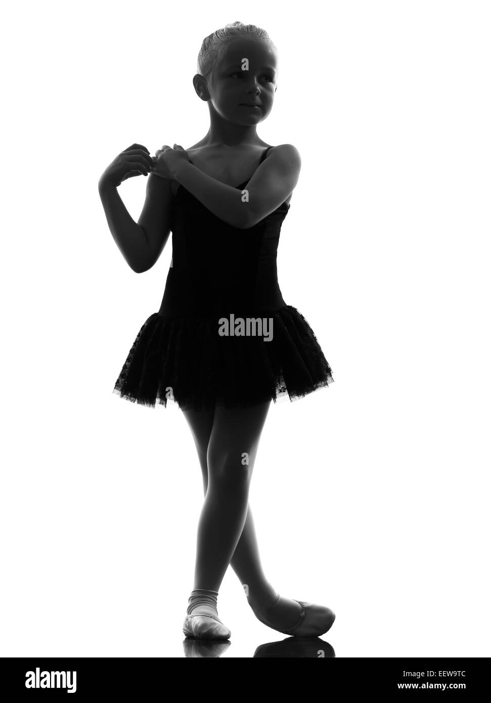one little girl ballerina ballet dancer dancing in silhouette on white background Stock Photo