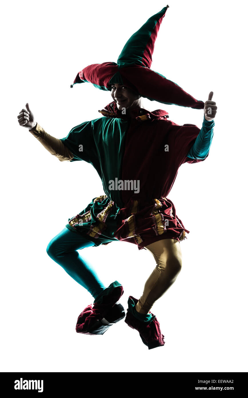 one caucasian man in jester costume jumping silhouette in studio isolated on white background Stock Photo