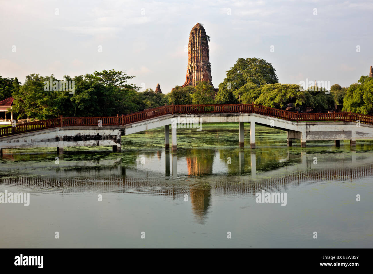 THAILAND - Bridge over a canal in Phra Ram Park located at center of the Ayutthaya Historical Park and the chedi at Wat Phra Ram Stock Photo