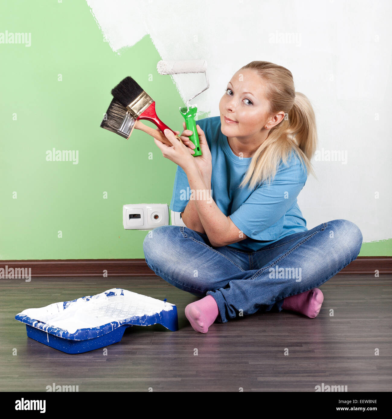 Young woman with paint tools in hands Stock Photo - Alamy