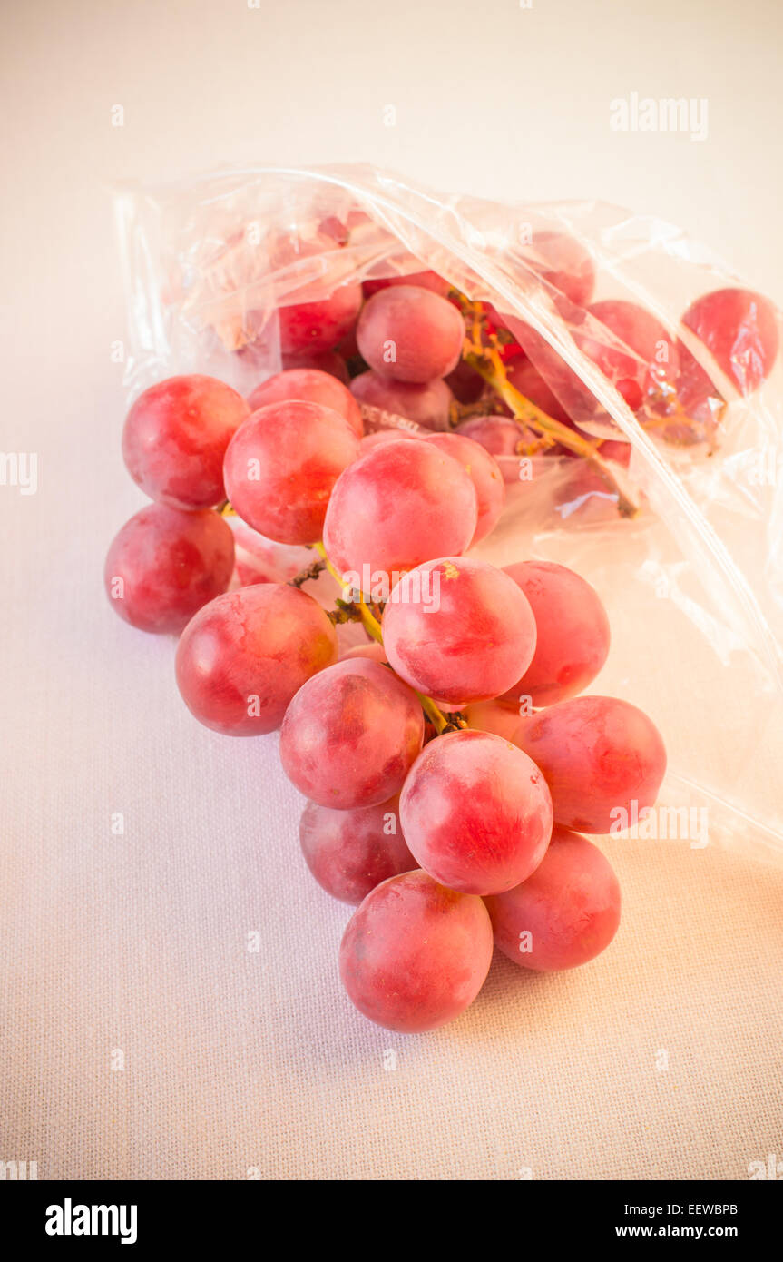 Grapes in a plastic bag on a white background Stock Photo Alamy