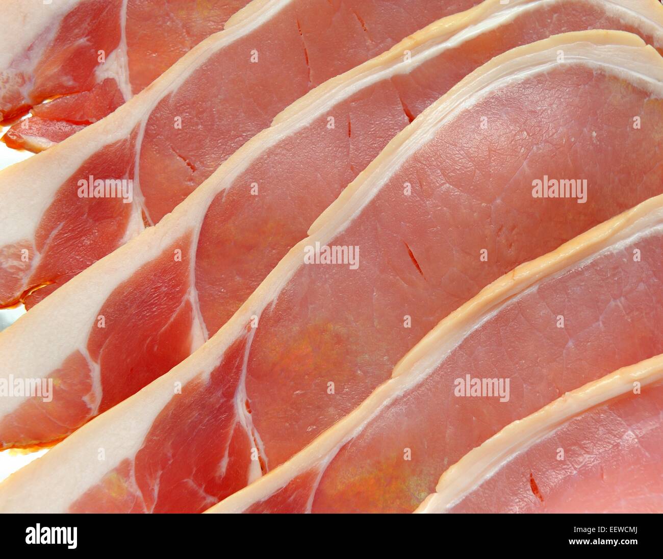 Rashers of raw uncooked smoked bacon Stock Photo