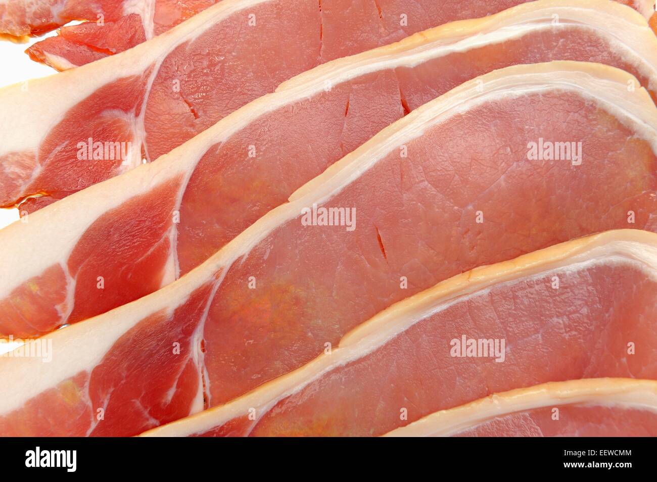 Rashers of raw uncooked smoked bacon Stock Photo