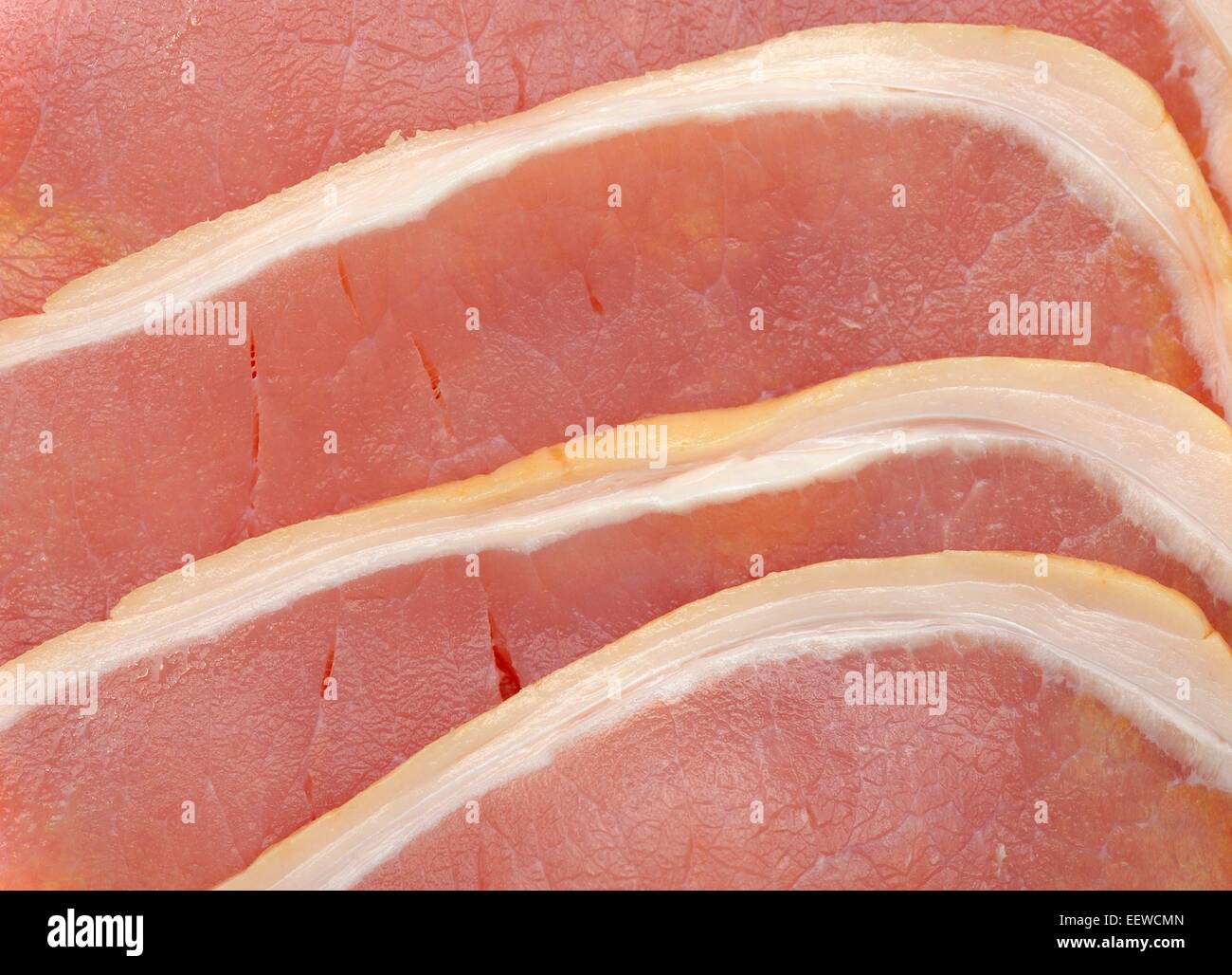 Rashers of raw uncooked smoked bacon Stock Photo