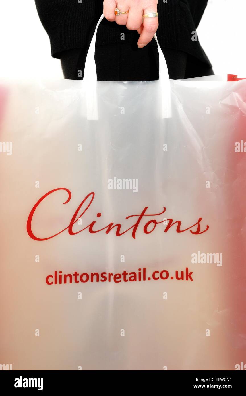 Clintons retail gift carrier bag being held by a female shopper England
