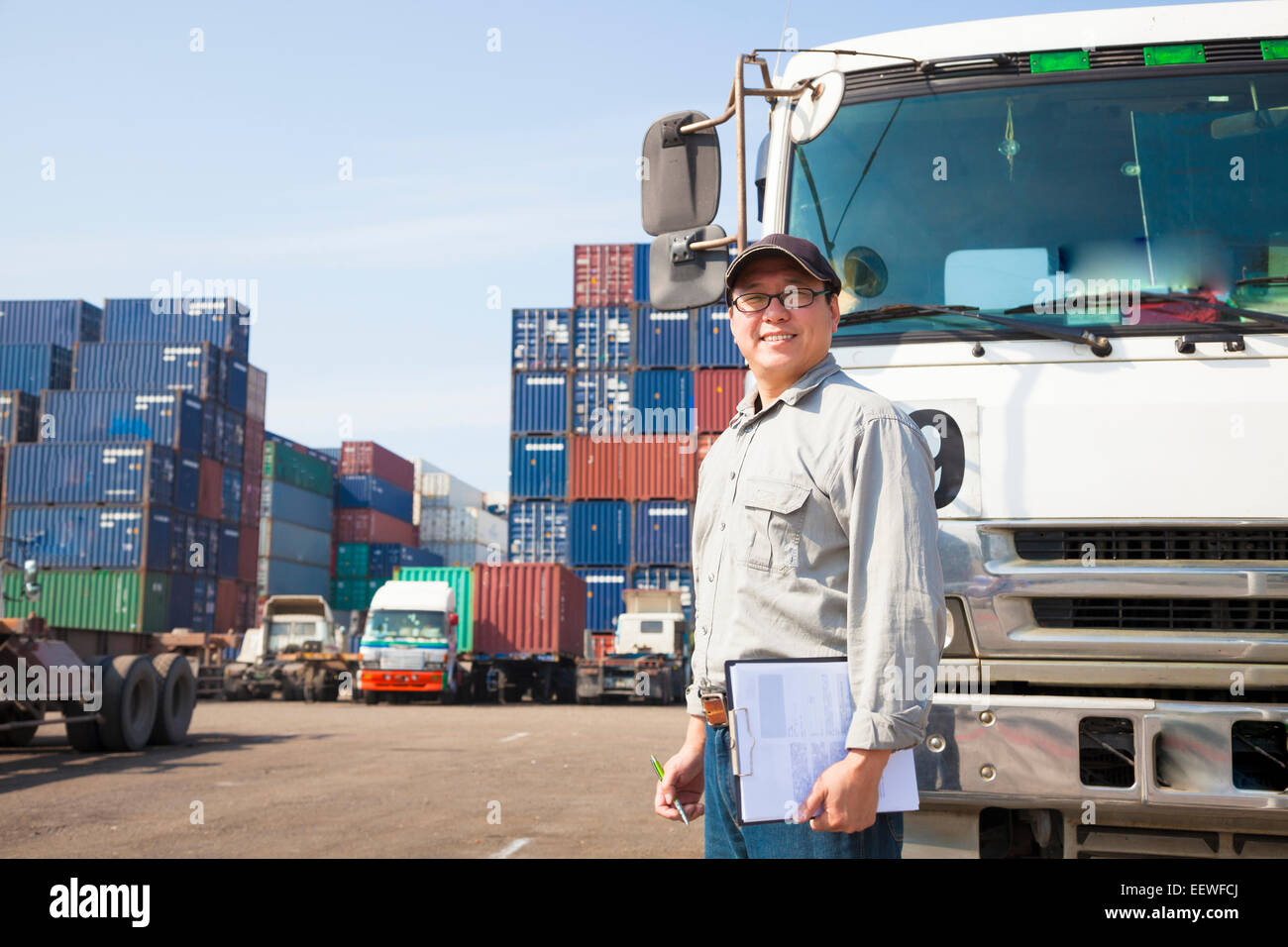 happy driver in front of container truck Stock Photo