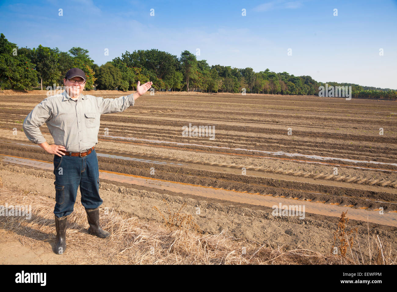 Farmer man showing his farming land Stock Photo
