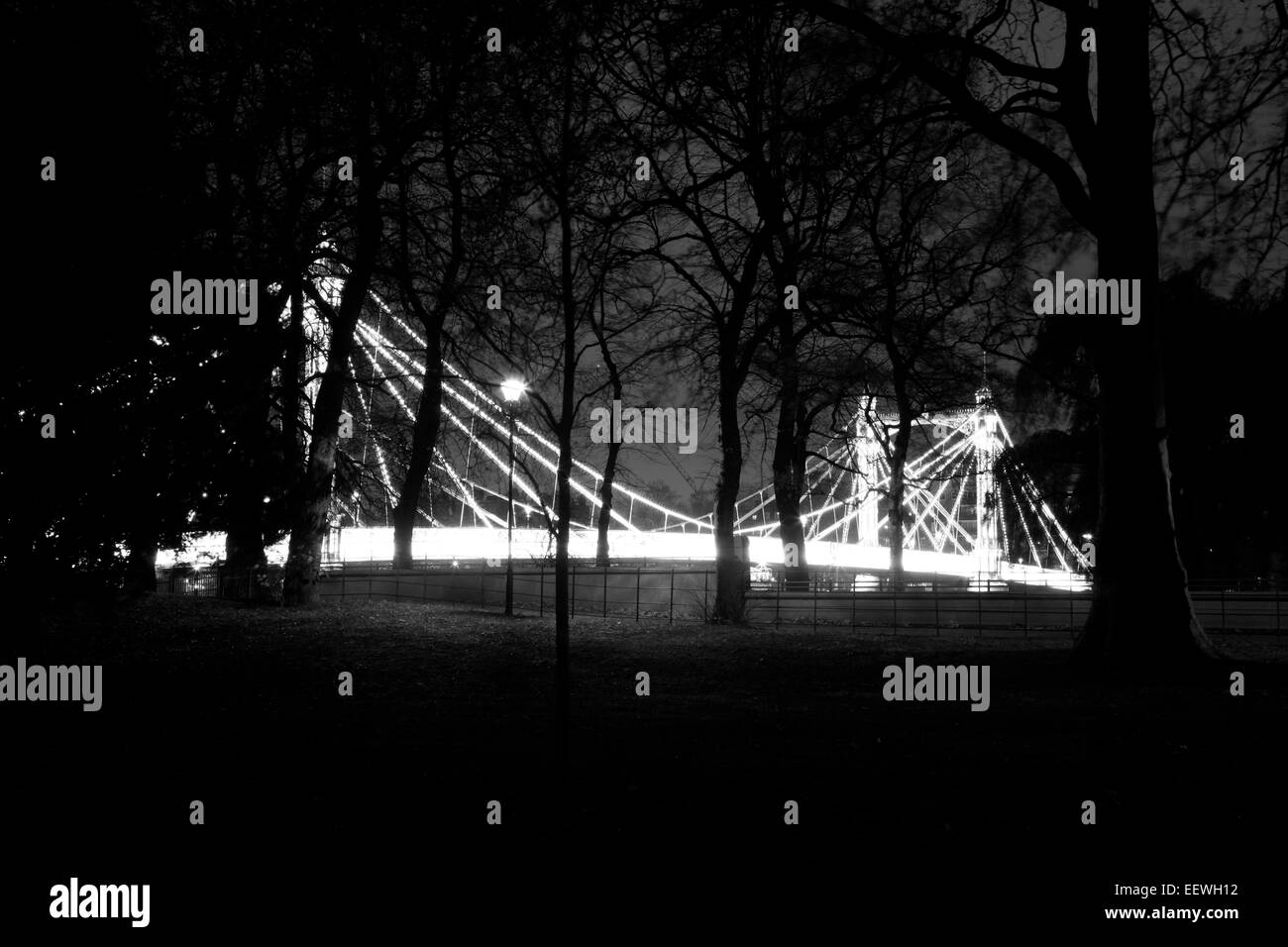 Night time view through Battersea Park to Albert Bridge, Battersea, London, UK Stock Photo