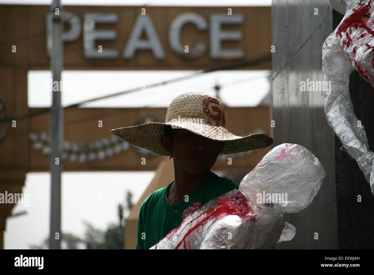 A protester sits near the Mendiola Peace Arch while they commemorate  the 28th anniversary of the massacre. (Photo by J Gerard Seguia / Pacific Press) Stock Photo