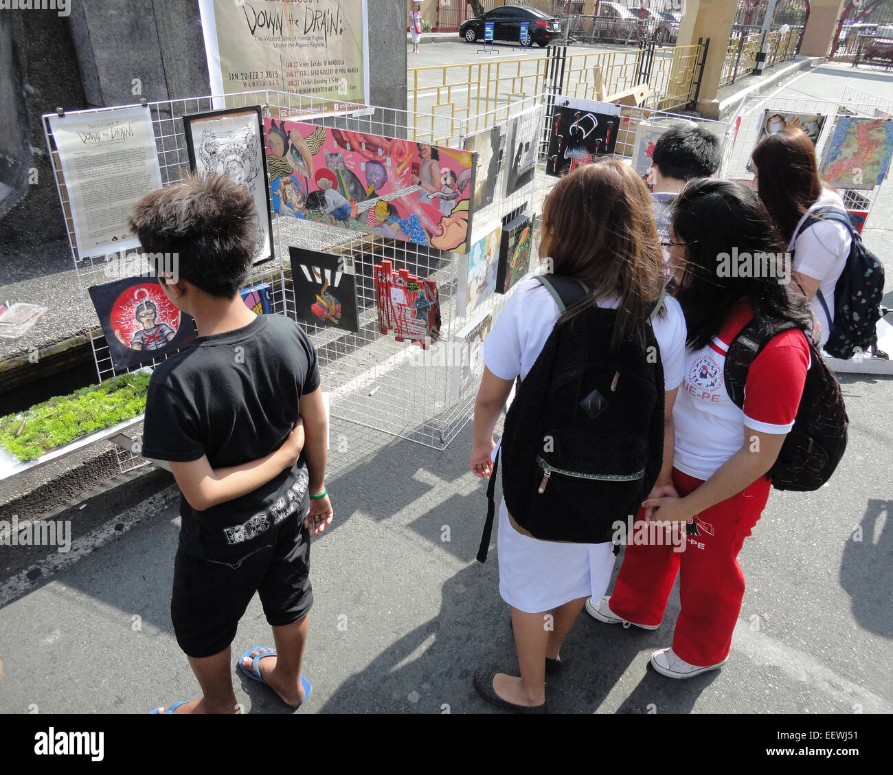 Students from a nearby university stop by an art exhibit in Mendiola Bridge, as Filipino protesters commemorate the 28th anniversary of the Mendiola Massacre that occured under the administration of President Benigno Aquino III's mother, former President Corazon Aquino, where thirteen farmers were killed. Anakpawis Partylist representative Fernando Hicap has filed a bill at Congress proposing to declare January 22, the anniversary of the Mendiola Massacre, a special holiday called 'Farmer's Day.' © Richard James Mendoza/Pacific Press/Alamy Live News Stock Photo