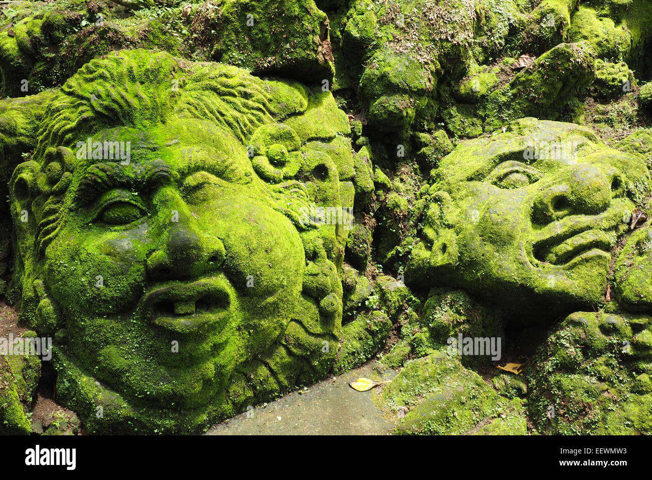 Moss covered rock sculptures in the gardens of Ayung Resort, Ubud, Bali