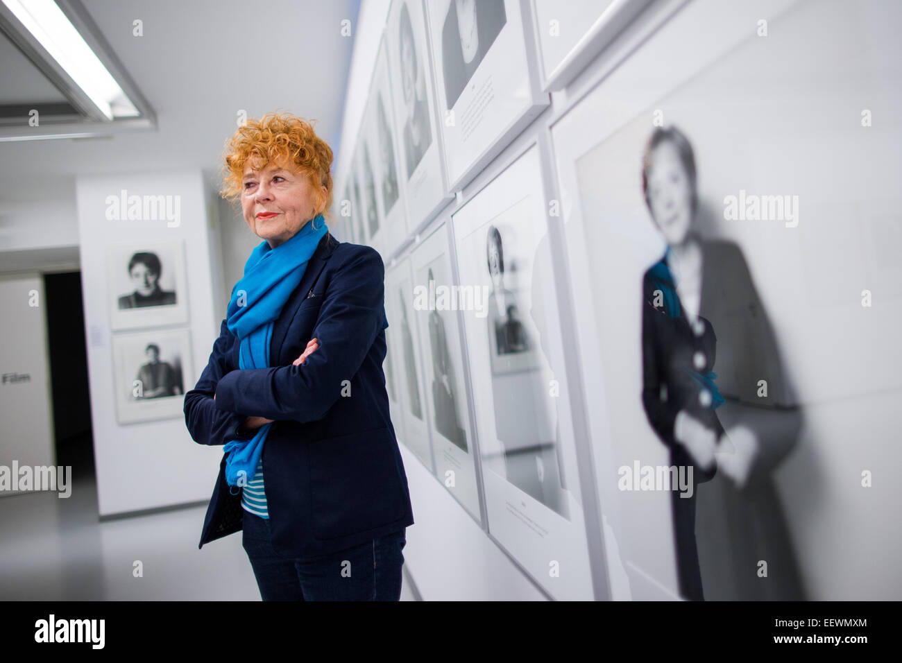 Photographer Herlinde Koelbl stands in front of a photograph from her series 'Spuren der Macht' (lit. Traces of Power) of Chancellor Angela Merkel in the Ludwig Galerie Schloss Oberhausen in Oberhausen, Germany, 22 January 2015. The exhibition (25 January 2015 to 3 March 2015) entitled 'Das deutsche Wohnzimmer, Spuren der Macht, Haare und andere menschliche Dinge - Fotografien von 1980 bis heute' (lit. The German living room, traces of power, hair, and other human things - Photographs from 1980 to today' brings together works from the German artist's important artistic phases. Photo: RALF VENN Stock Photo