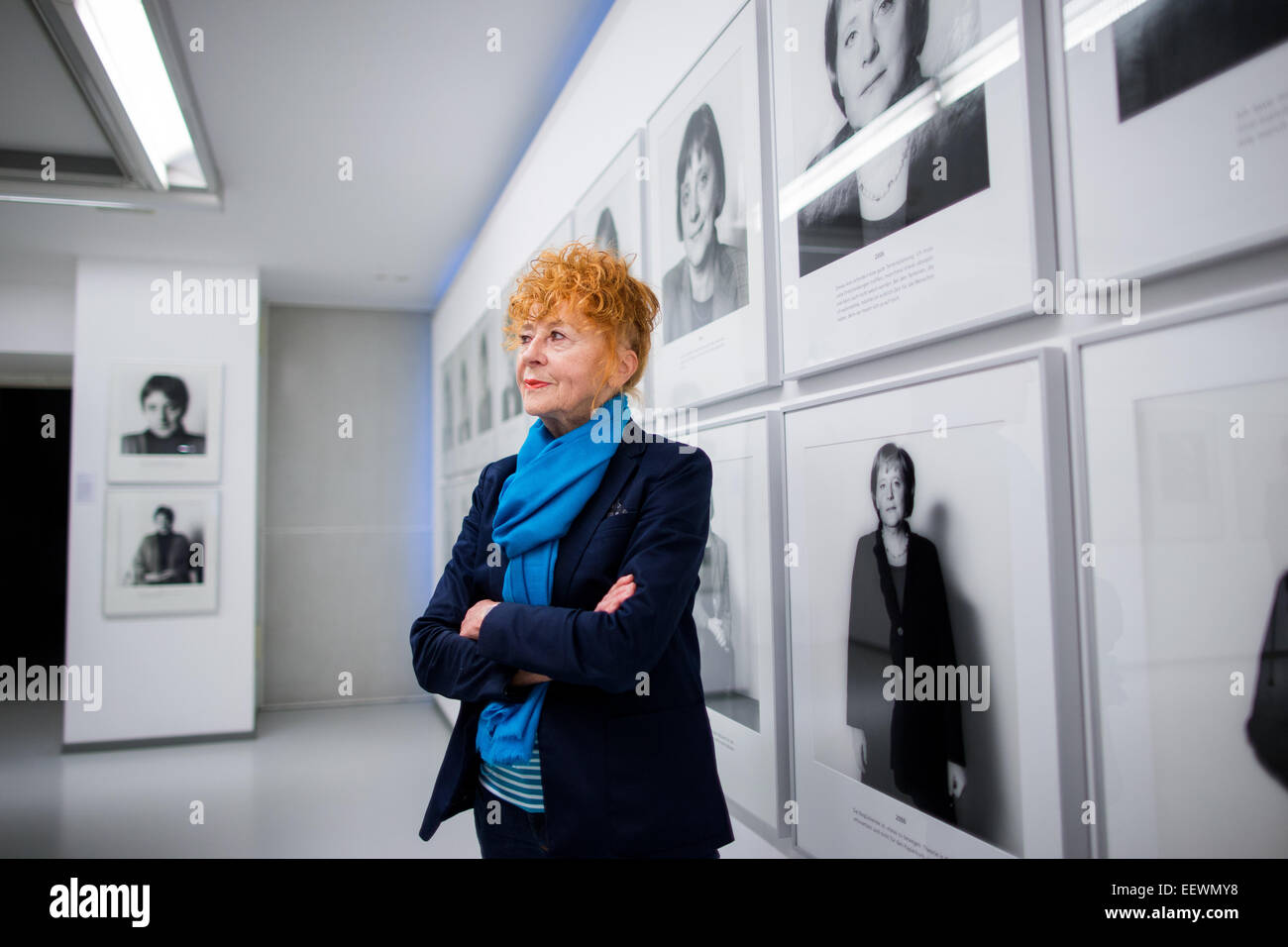 Photographer Herlinde Koelbl poses in front of photographs from her series 'Spuren der Macht' (lit. Traces of power) in the Ludwig Galerie Schloss Oberhausen in Oberhausen, Germany, 22 January 2015. The exhibition (25 January 2015 to 3 March 2015) entitled 'Das deutsche Wohnzimmer, Spuren der Macht, Haare und andere menschliche Dinge - Fotografien von 1980 bis heute' (lit. The German living room, traces of power, hair, and other human things - Photographs from 1980 to today' brings together works from the German artist's important artistic phases. Photo: RALF VENNENBERND/dpa Stock Photo