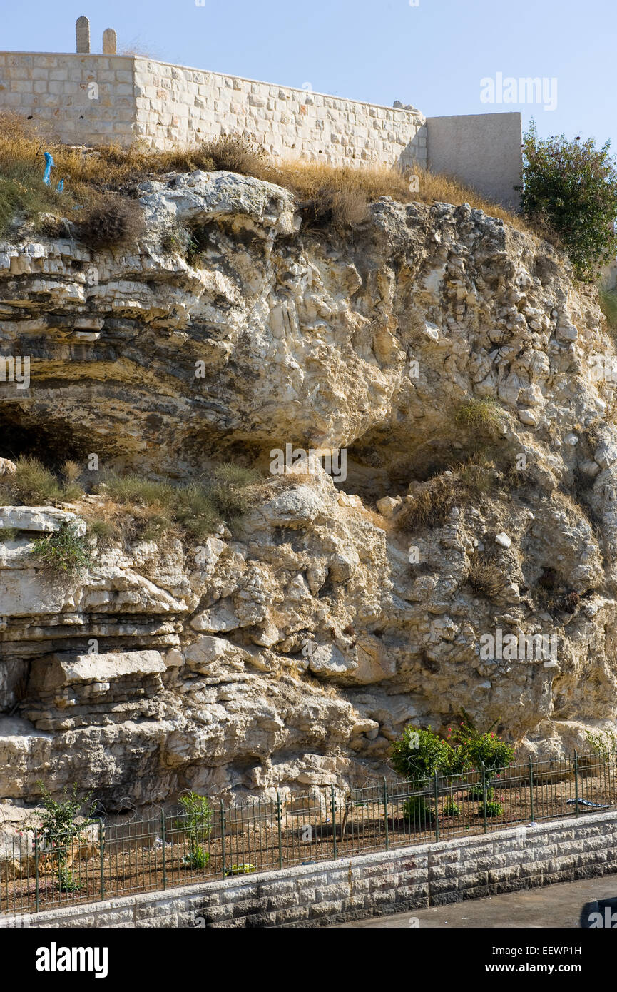 Rock with the shape of a skull near the Garden Tomb in Jerusalem. Pilgrims believe that this could be the rock Golgotha. Stock Photo