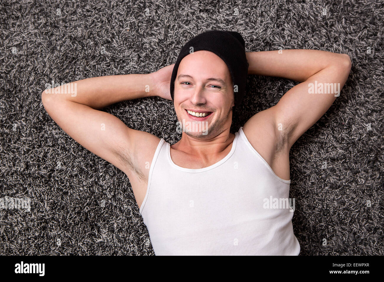 Attractive young man in a white shirt smiles at the camera Stock Photo