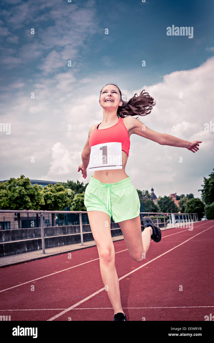 female athletic sportswoman on a track in the stadium Stock Photo